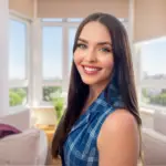 Smiling woman with long dark hair in a bright room.