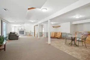 Spacious basement with seating areas and neutral decor.