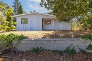 Single-story house with a dry front yard and concrete driveway.