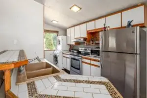 Kitchen with washer and tiled island. - 8587