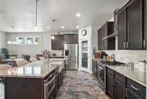 Modern kitchen with dark cabinets and a large island.