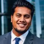 Portrait of a smiling young man in a suit and tie.