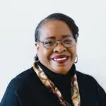 Smiling woman with glasses and scarf